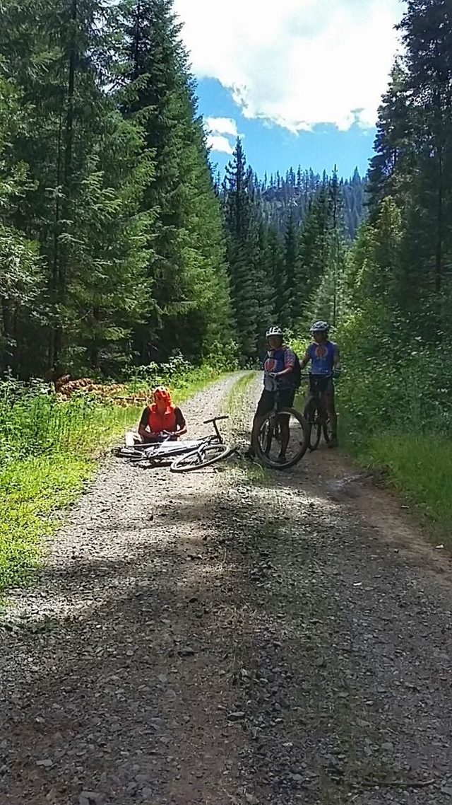 Sometimes those bumpy descents do things to one's tires. John fixes the only flat of the day. He ended up needing a good-sized repair boot inside his tire after a rock put a nice gash in it.
