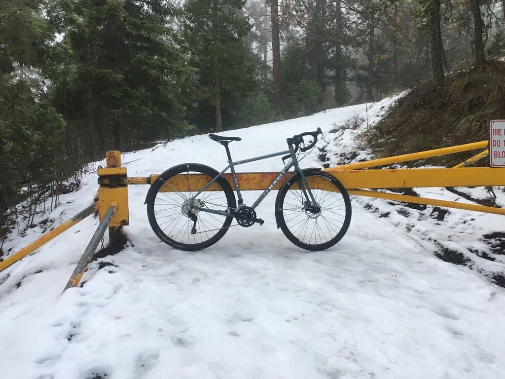 Shortly after I first got the bike, ascending packed snow on the stock 700c wheels and Clement X'Plor MSO tires. I added fenders for the winter months.